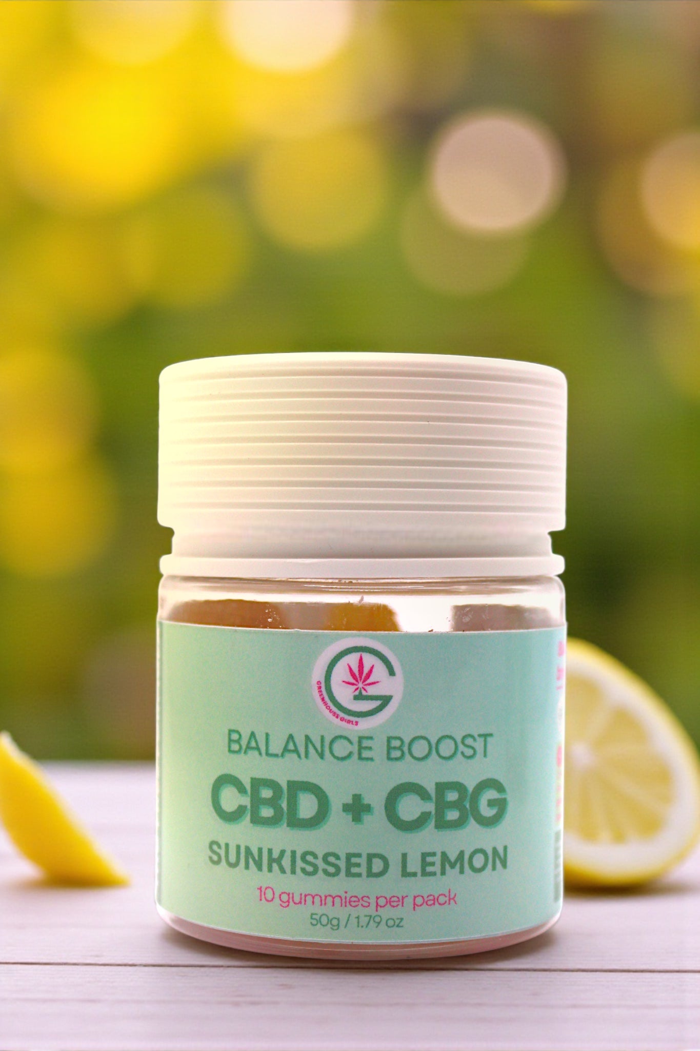 Jar of Balance Boost CBD + CBG gummies with a blurred green outdoor background