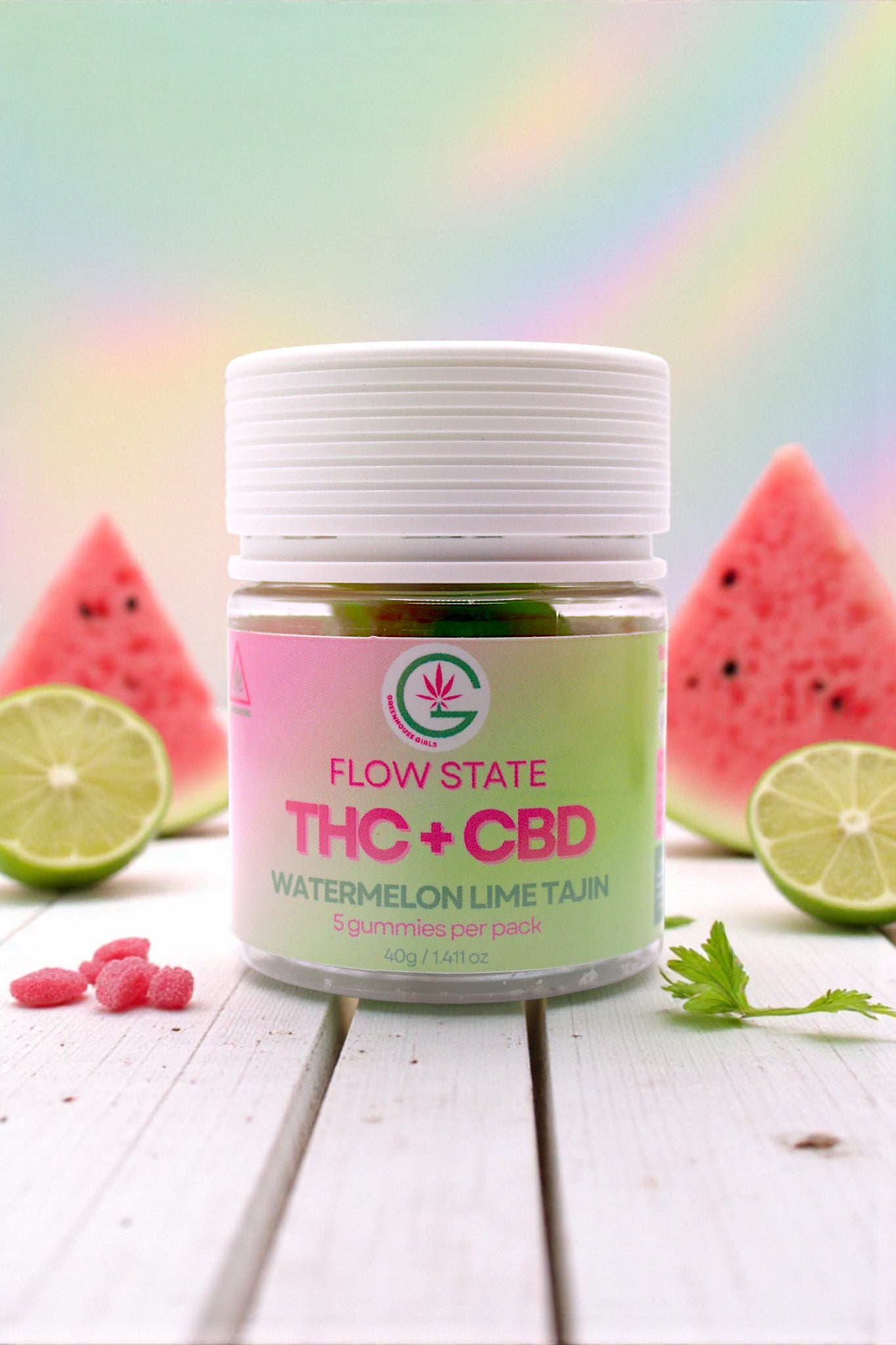 Jar of Flow State THC + CBD Watermelon Lime Tincture on a wooden surface with watermelon and lime slices.
