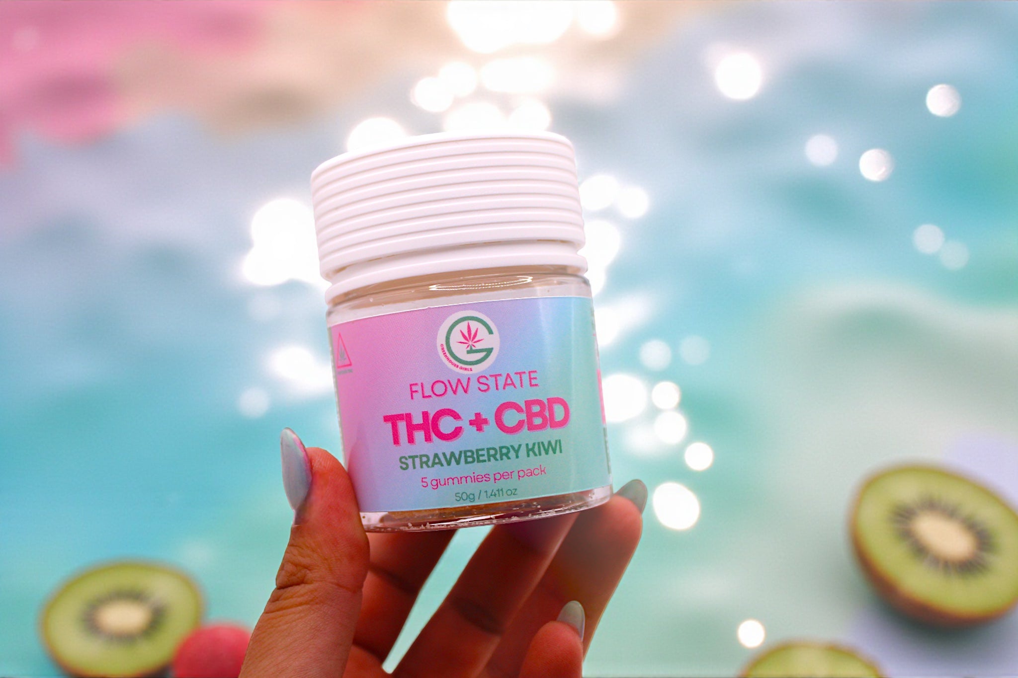 Hand holding a container labeled 'Flow State THC + CBD Strawberry Kiwi' with a colorful blurred background.
