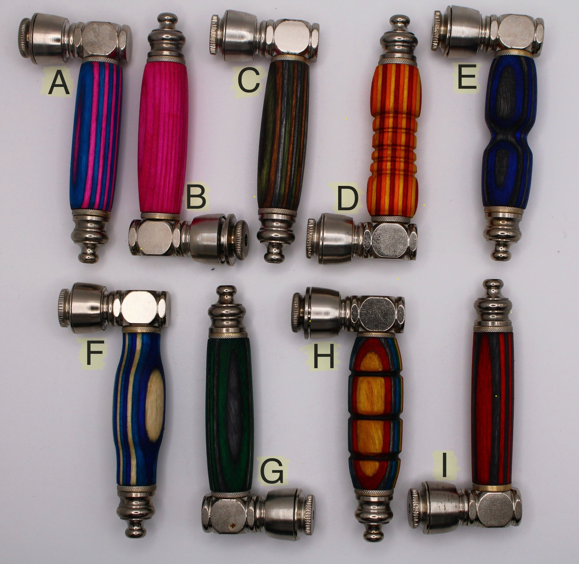 Assorted metal handles with colorful wooden grips on a white background