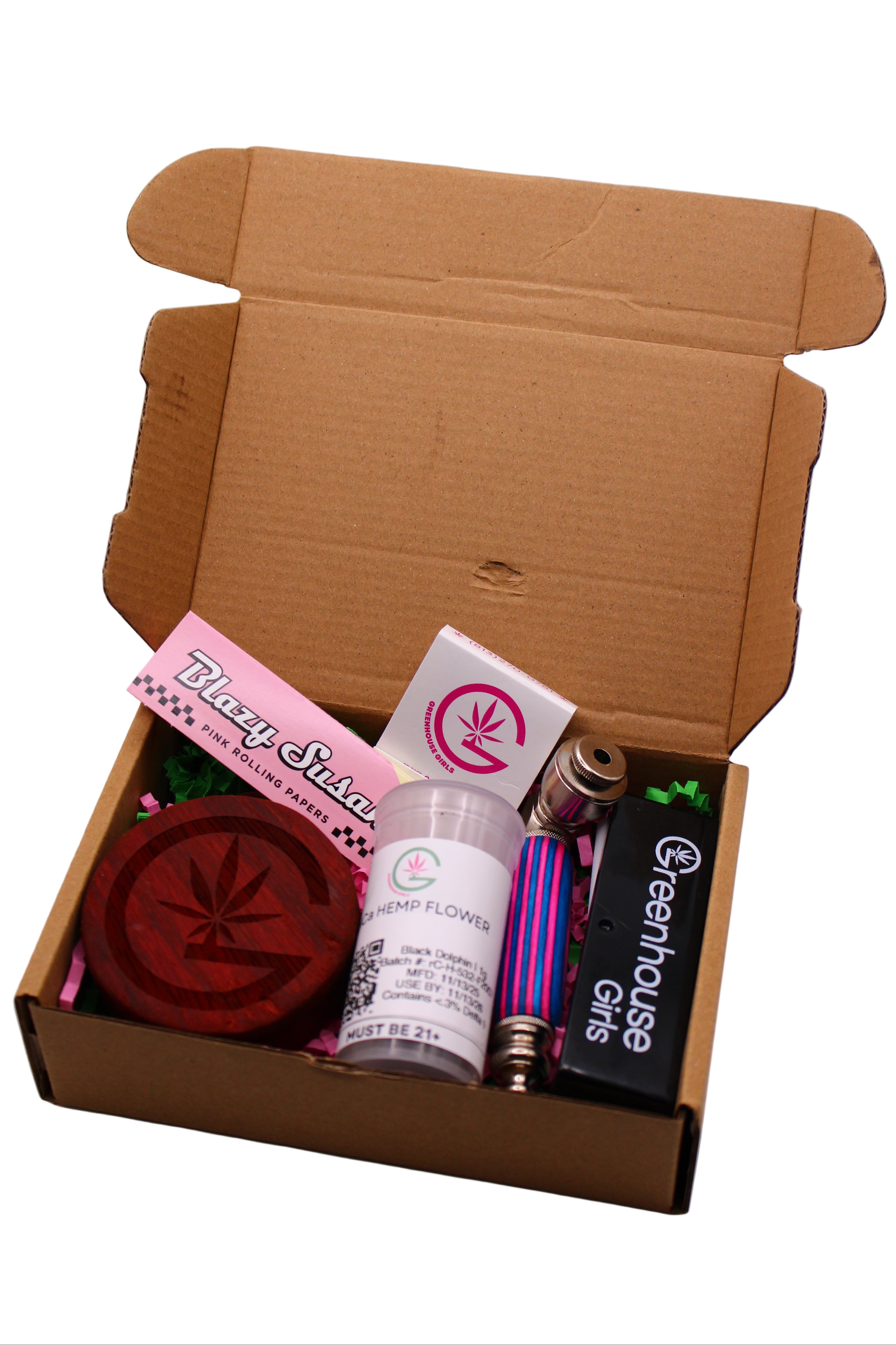 Open cardboard box containing cannabis products with visible branding on a white background