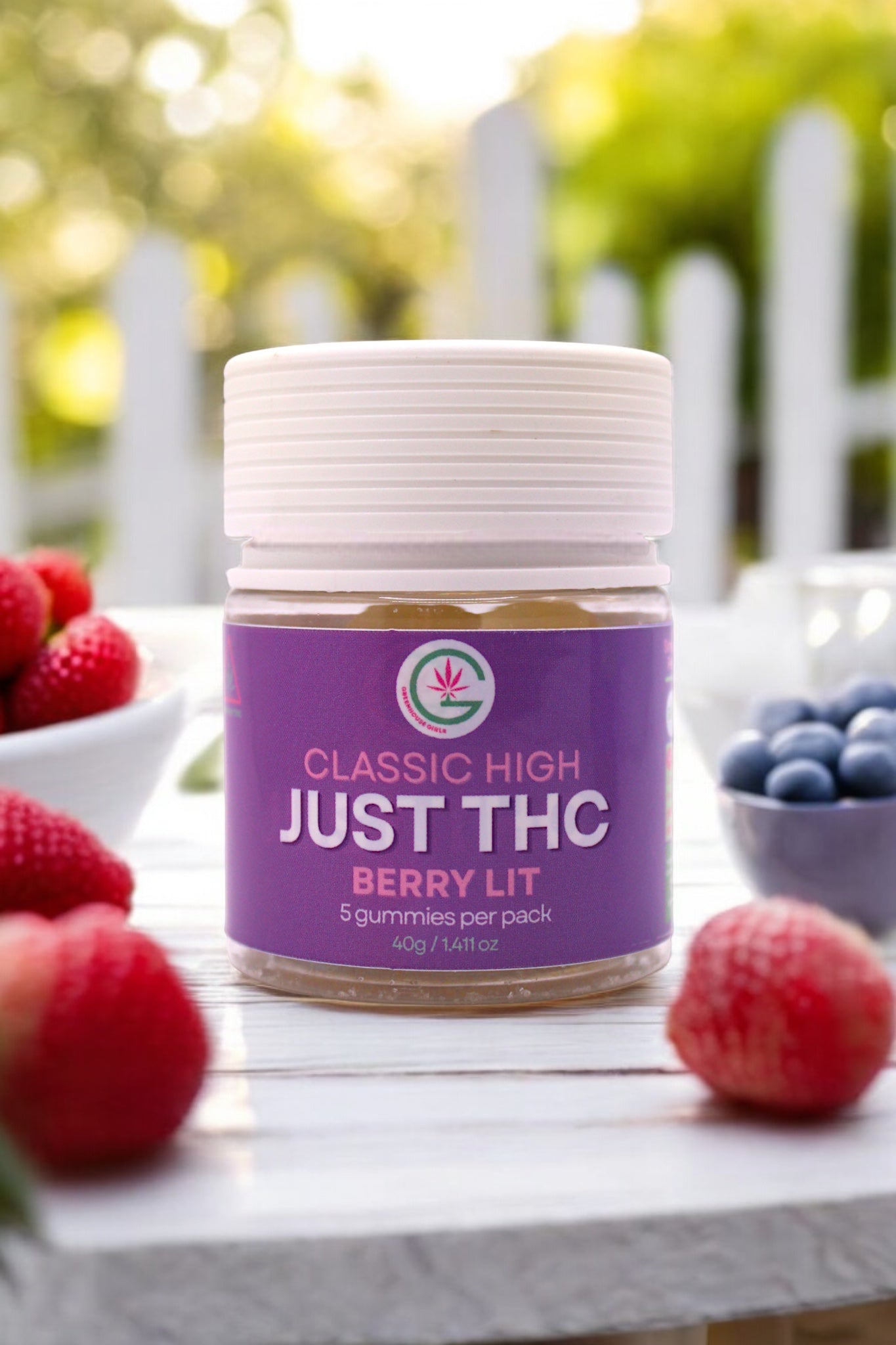 Jar of 'Just THC' gummies with berries on a table