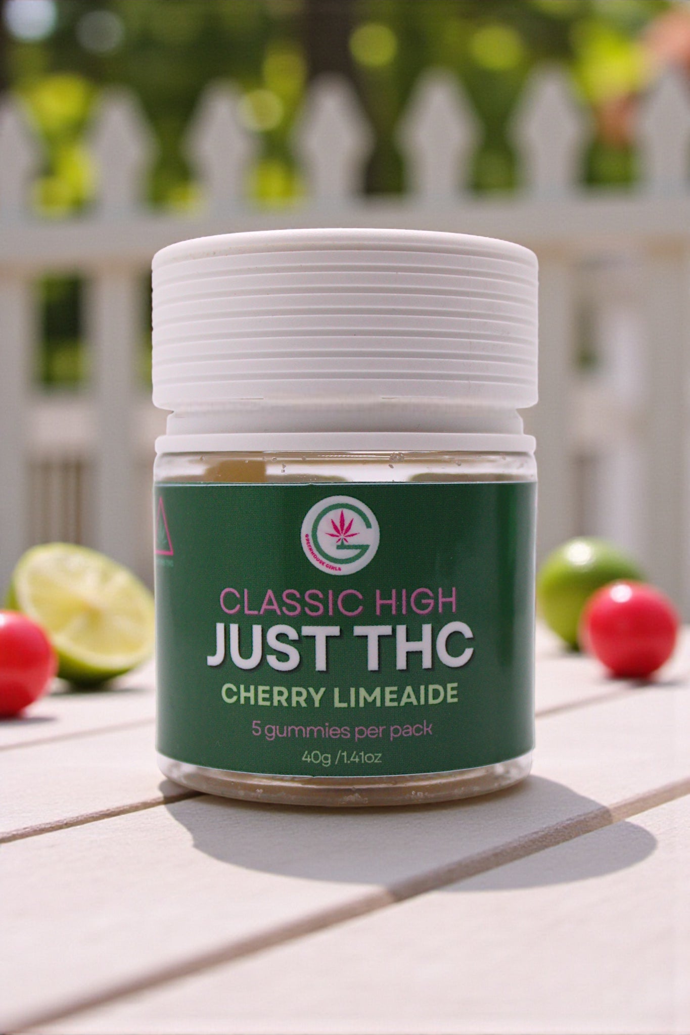 Jar of 'Just THC' gummies with cherry limeade flavor on a wooden surface.