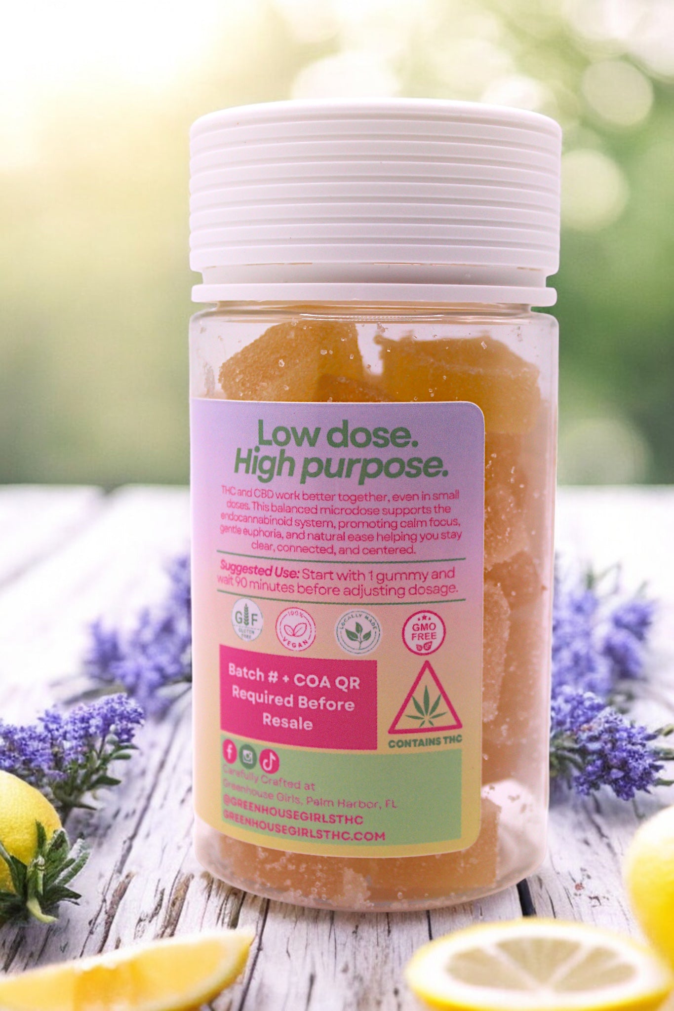 Supplement bottle with label on a wooden surface with lemons and lavender