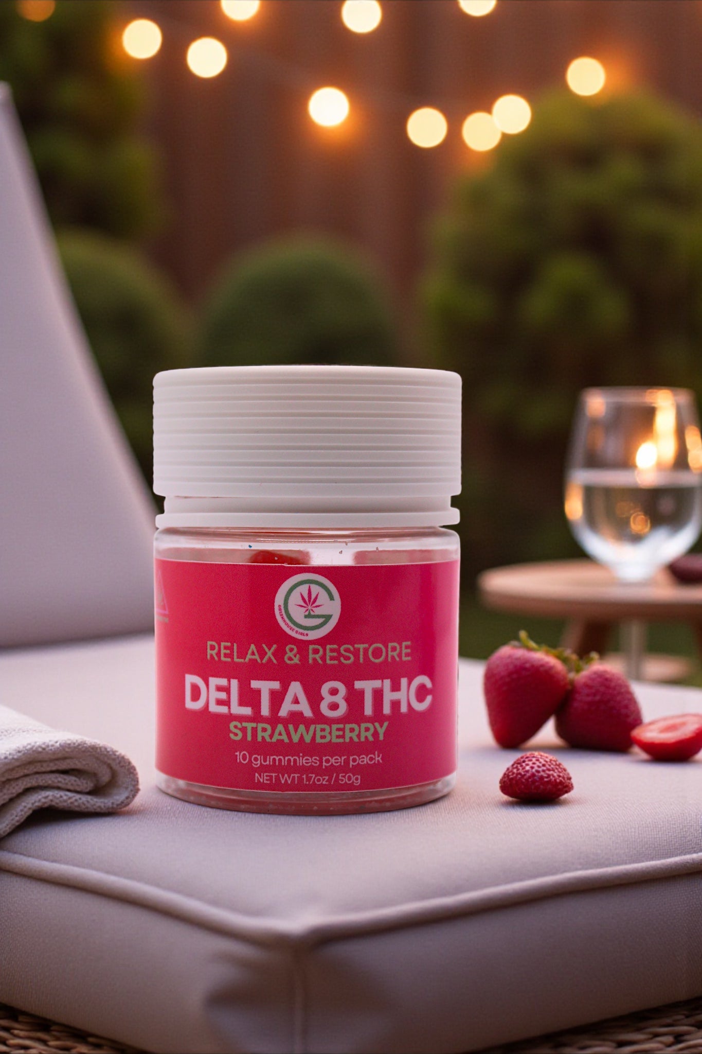 Jar of Delta 8 THC Strawberry product on a surface with strawberries and blurred lights in the background