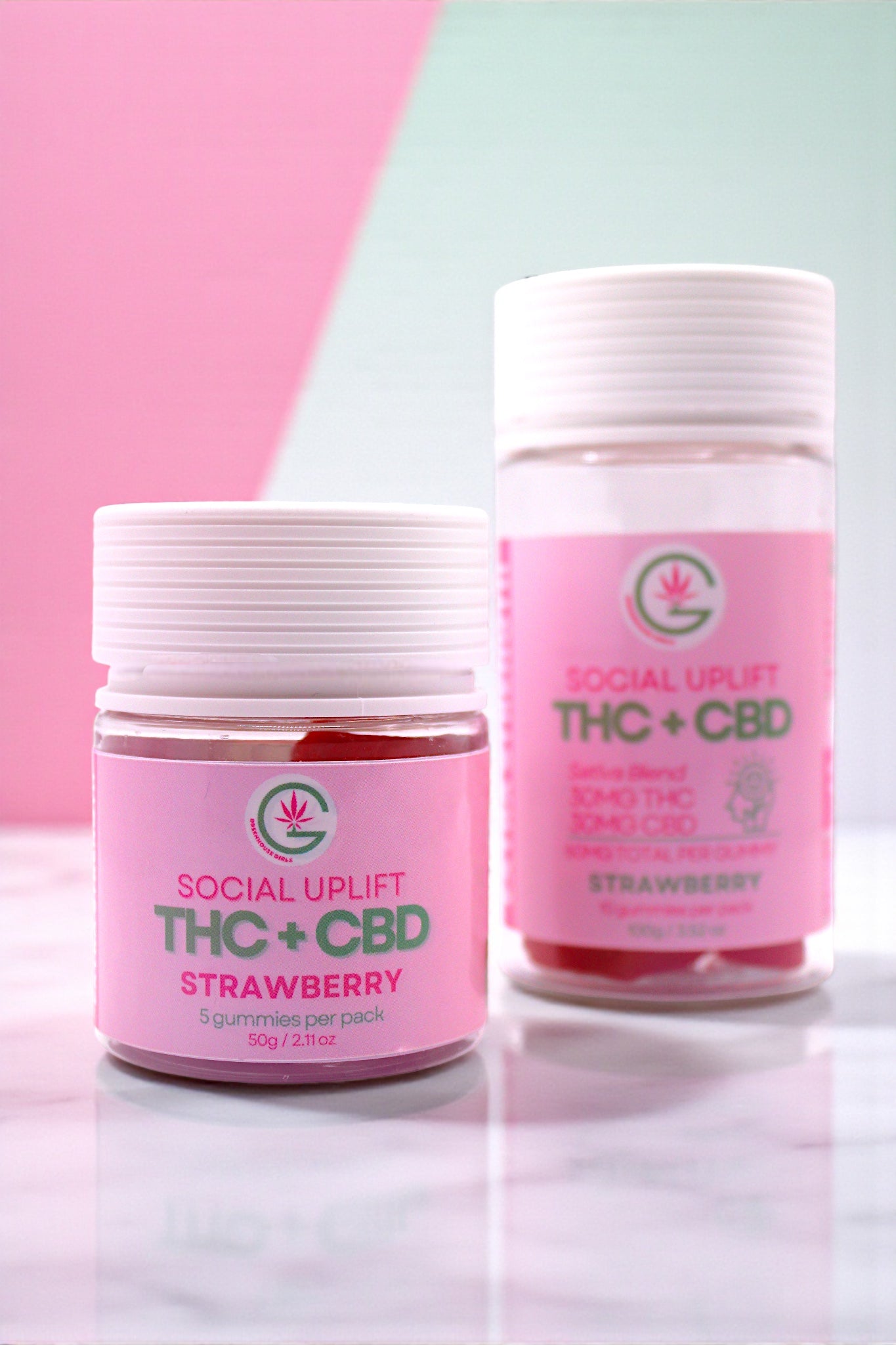 Two containers labeled 'Social Uplift THC + CBD Strawberry' on a light background