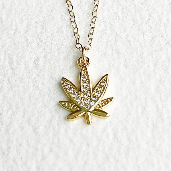 Greenhouse Girls 16k gold-dipped cannabis leaf pendant necklace encrusted with shimmering cubic zirconia crystals.